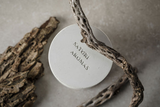 Close-up of Satori Aromas concrete candle jar showing premium craftsmanship